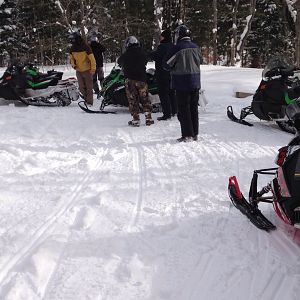 Antrim County Snowmobile Club guiding 15 German and Mexican Visitors on their first Snomobile ride, what a blast, most of the Mexicans never saw snow prior to their visit but were riding with abandon 3-4 hours into the ride!

The team's corporate leader from Germany wanted to go 100 MPH on a sled.  We told him his rental would top out at about 65 MPH.  We asked them back next year and told him we would try and find something to ride that would get him to 100 MPH.

We're stopped on the side of the Jordan Valley Trail looking up to Dead Mans Hill that we visited earlier in the ride.  Club members are Mike Null, President of the Antrim County Snowmobile Club with Jeanne and Chris Kortier who also groom three days a week for the Jordan Valley Trail Council.